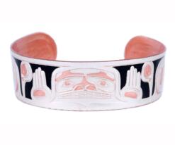 Handmade copper embossed bracelet created in Native Haida design with black background