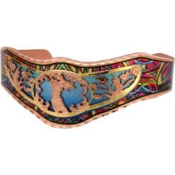 Elegant cut out angel bracelet embellished with a colorful copper cuff as background.