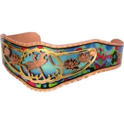 Buy delicately cut out dragonfly bracelet embellished with a colorful copper cuff as background.