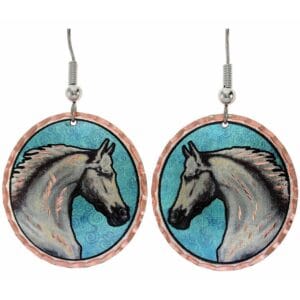 Handcrafted copper earrings featuring a pretty horsehead design on a round blue patina background, demonstrating how to create handcrafted jewelry using patinas.