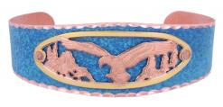 Intricate cut out gold and copper cut out eagle bracelet accentuated with the blue patina background