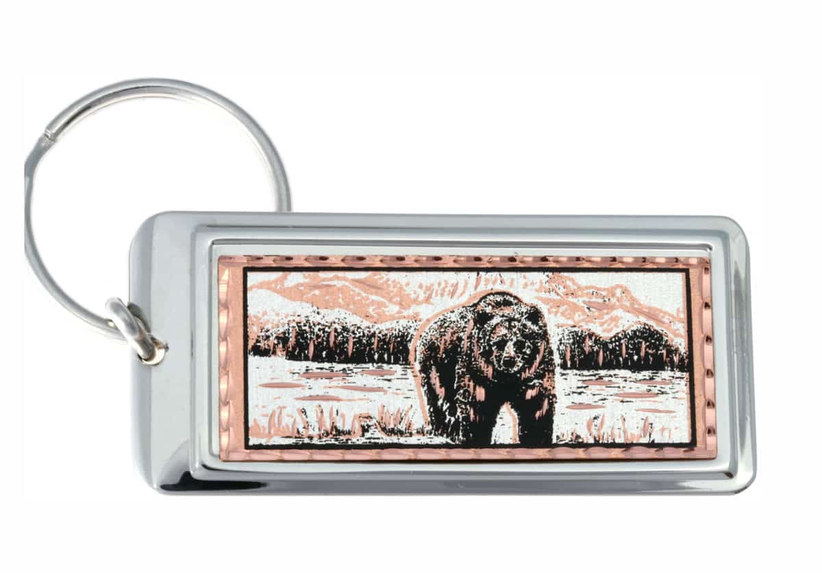 Rectangular silver-plated keychains decorated with copper grizzly bear artwork Rectangular silver-plated keychains decorated with copper grizzly bear artwork