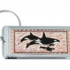 Rectangular silver-plated keychains decorated with copper killer whales artwork