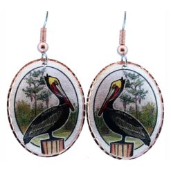 Close-up of handcrafted copper Louisiana pelican earrings featuring a detailed bayou nature scene.