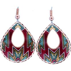 The earrings feature a geometric, Southwest Native American-inspired pattern incorporating turquoise, deep red, brown, and black sections, with a prominent red diamond motif in the center. The outer copper edges have a textured, diamond-cut finish that catches the light.