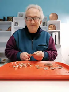 How We Make Copper Jewelry: Artisan cutting handmade copper earrings by hand using specialized jewelry shears.