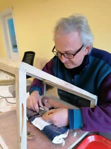 How We Make Copper Jewelry: Artisan using a high-speed diamond cutter tool to carve facets on copper jewelry.