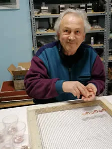 How We Make Copper Jewelry: Lining up pieces on a wire mesh screen to spray with protective acrylic finish.