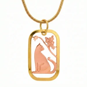 An intricate feline design finely etched into a two-tone copper and gold coin-style pendant, draped from a gold-tone snake chain.