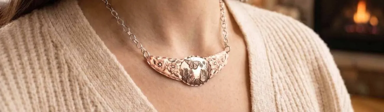 Banner for handmade choker necklace collections featuring a model wearing unique copper jewelry in a warm setting.